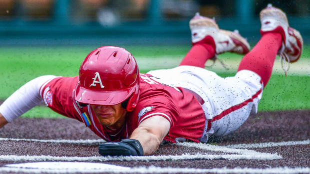 Arkansas first baseman Brady Slavens slides into home head first against Vanderbilt.